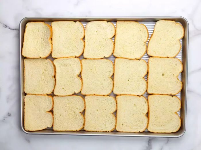 Aerial view of a baking dish filled with bread slices, ready for stuffing preparation.