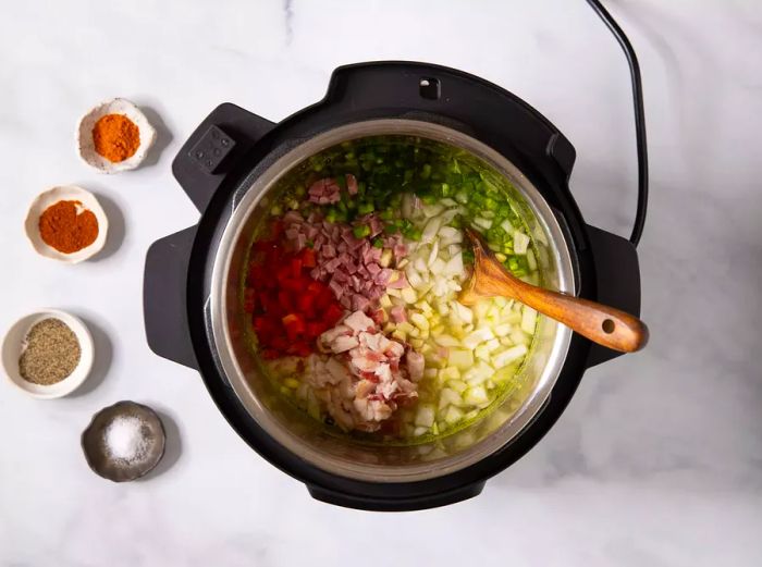 Aerial view of black-eyed pea ingredients in a slow cooker, ready to be mixed.