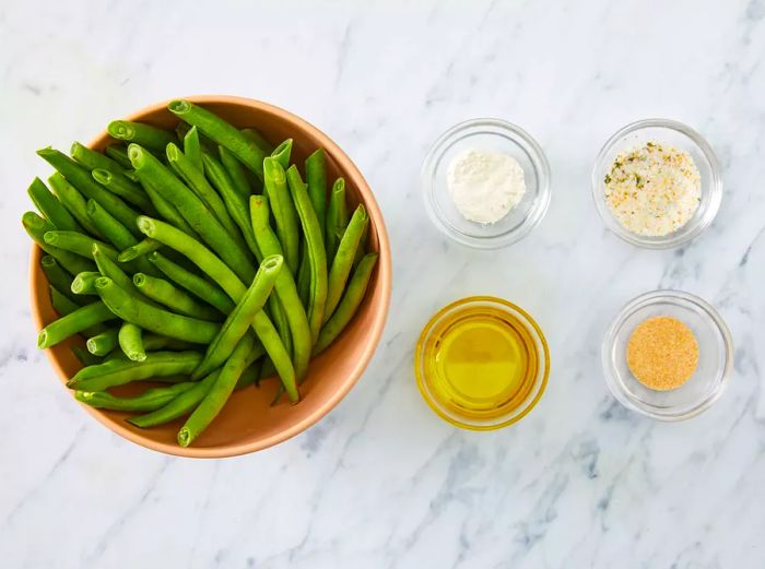 Top view of green bean ingredients arranged in bowls.