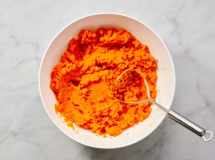 A bowl of mashed sweet potatoes, ready for the casserole.