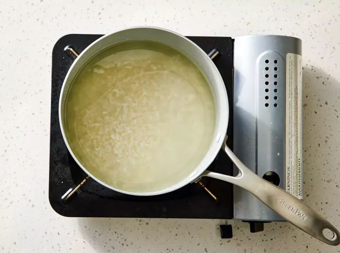 Rice soaking up the water in the pot