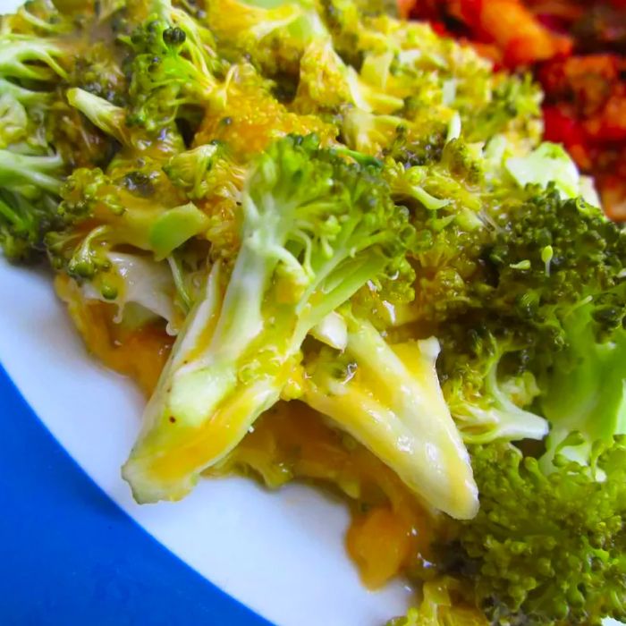 Close-up shot of broccoli and cheese served on a plate