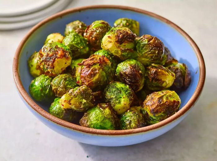 Close-up shot of a bowl of crispy air fryer Brussels sprouts