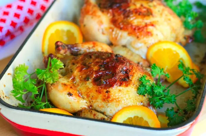 A roasting pan filled with Cornish hens