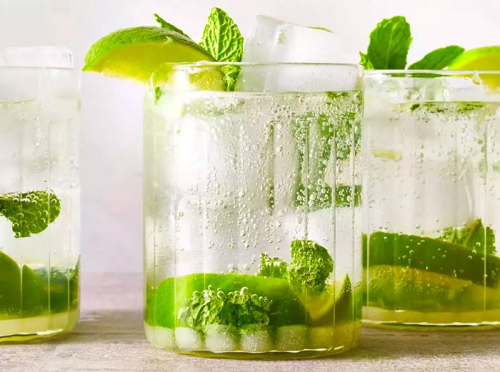 A view from eye level showing several mojito cocktails.