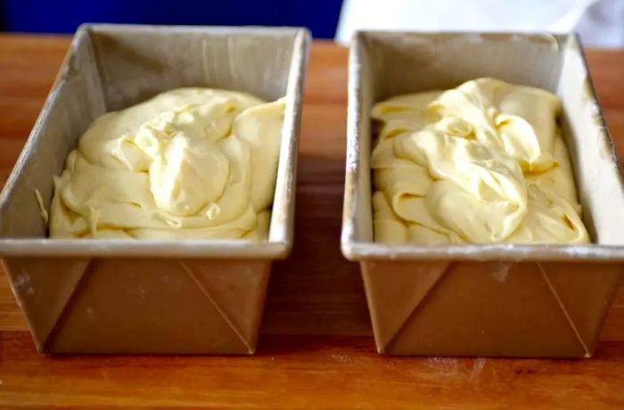 Two loaf pans filled with cake batter