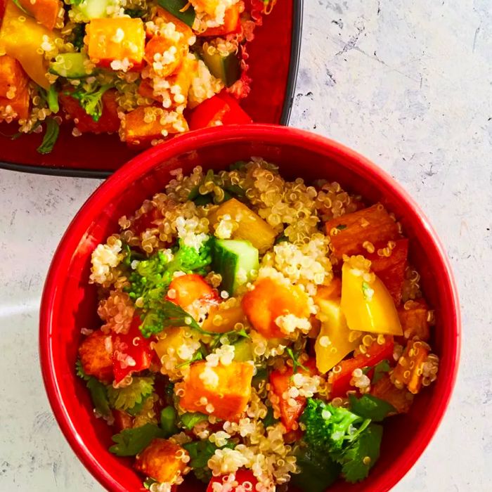 Roasted Sweet Potato Quinoa Salad served on red plates