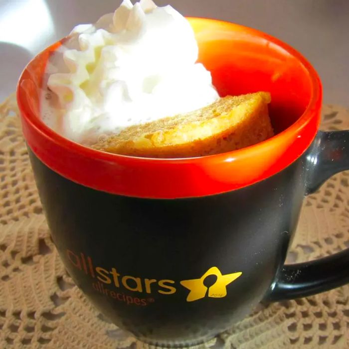 Pumpkin Pie Mug Cake served in a black and orange mug