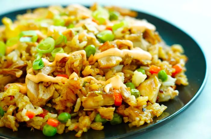 A close-up of Easy One-Pan Chicken Fried Rice with peas and carrots