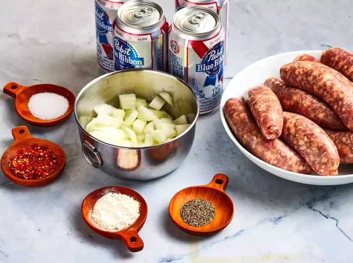 An overhead shot showcasing the beer brat ingredients and spices arranged in various bowls and containers.