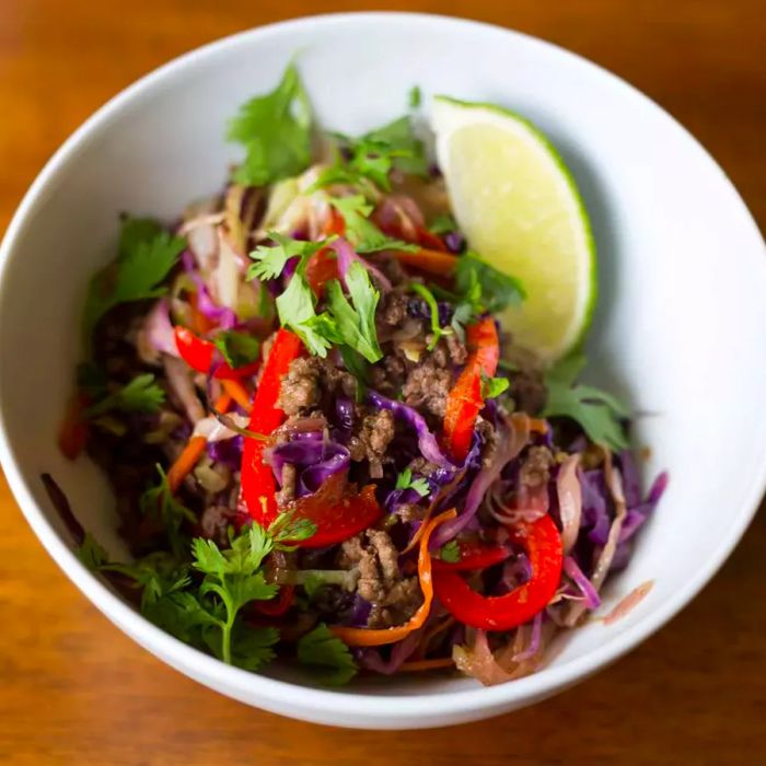 Deliciously addictive Asian Beef Slaw served in a white bowl