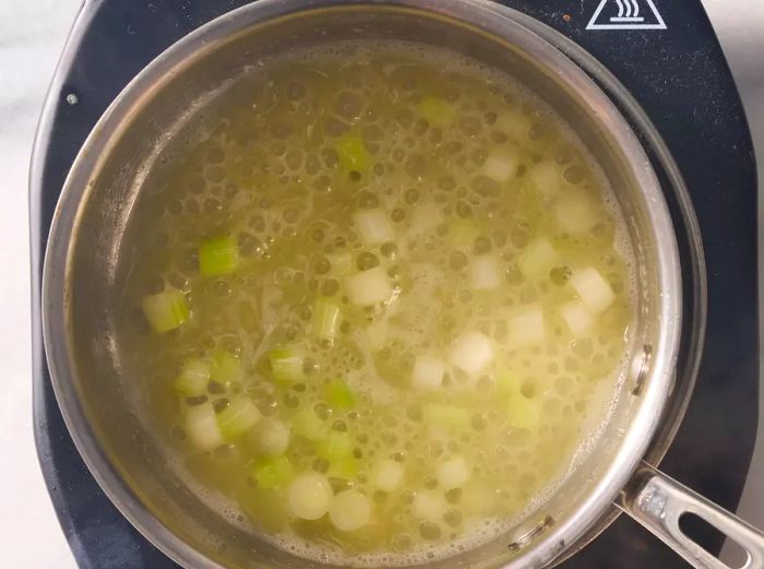 butter and seasoning mixture blending together in a saucepan