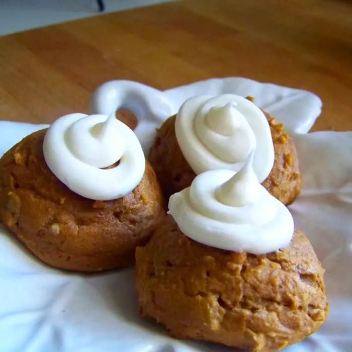 Extra Easy Pumpkin Cookies topped with swirls of frosting