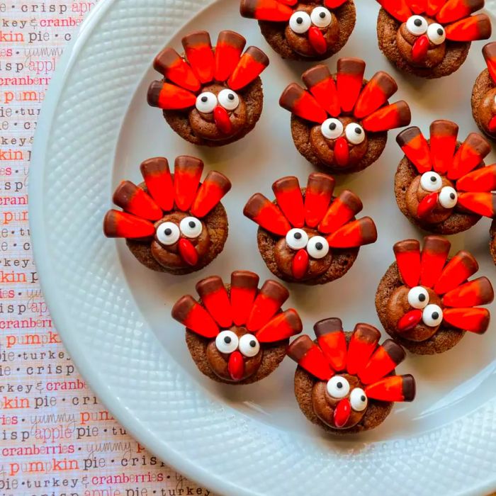 Plate of Mini Turkey Brownies decorated with candy corn feathers, googly eyes, and red candy noses