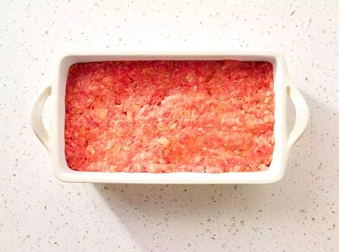 The meatloaf mixture in the loaf pan, ready to bake