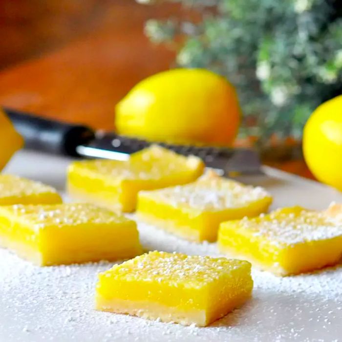 Lemon Pie Bars elegantly arranged on a white marble board