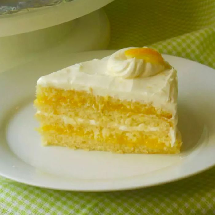 A top-down view of a single slice of lemon cake elegantly placed on a plate