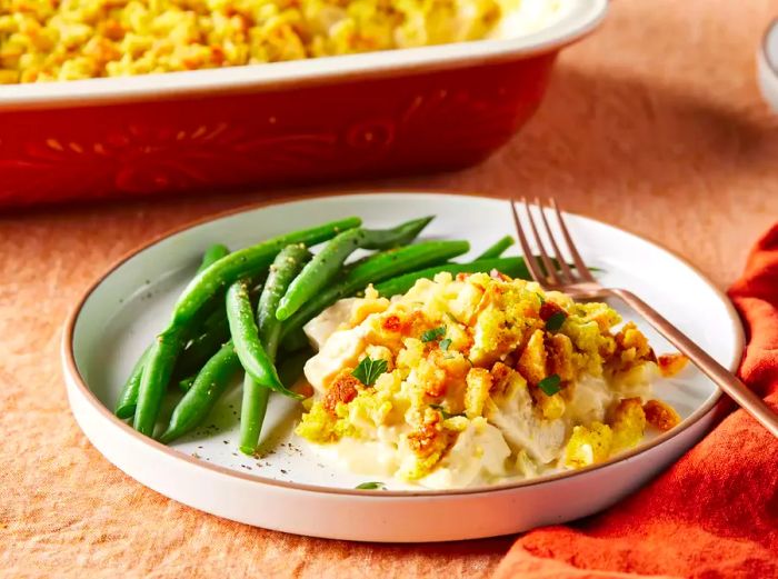 A plate of Aunt Jewel's chicken dressing casserole, served with green beans