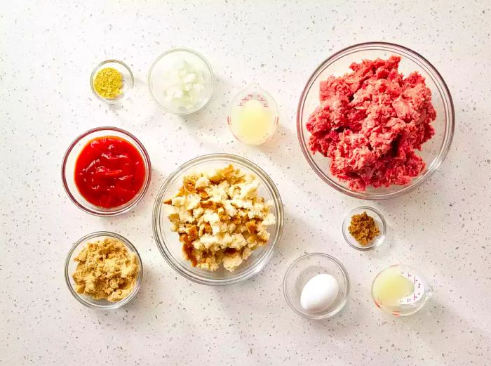 Ingredients for Glazed Meatloaf displayed in glass bowls