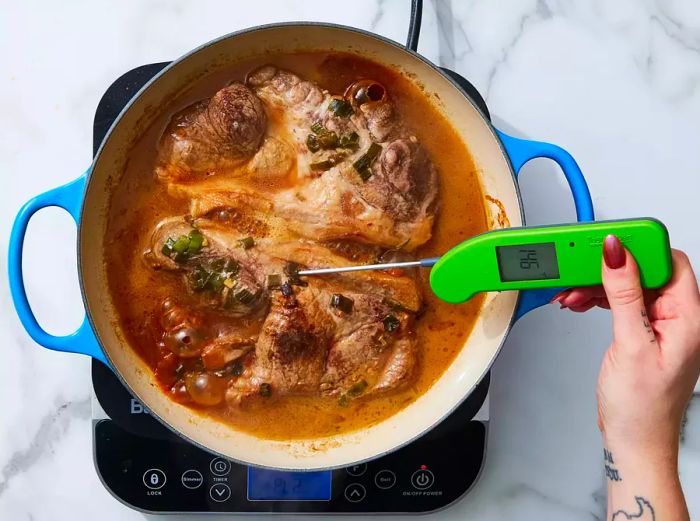 Pork steaks sizzling in a skillet