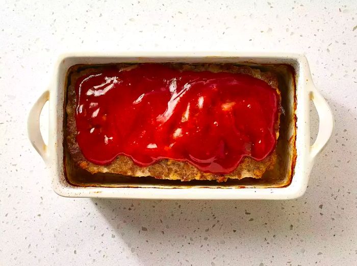 Glazed Meatloaf resting in a loaf pan