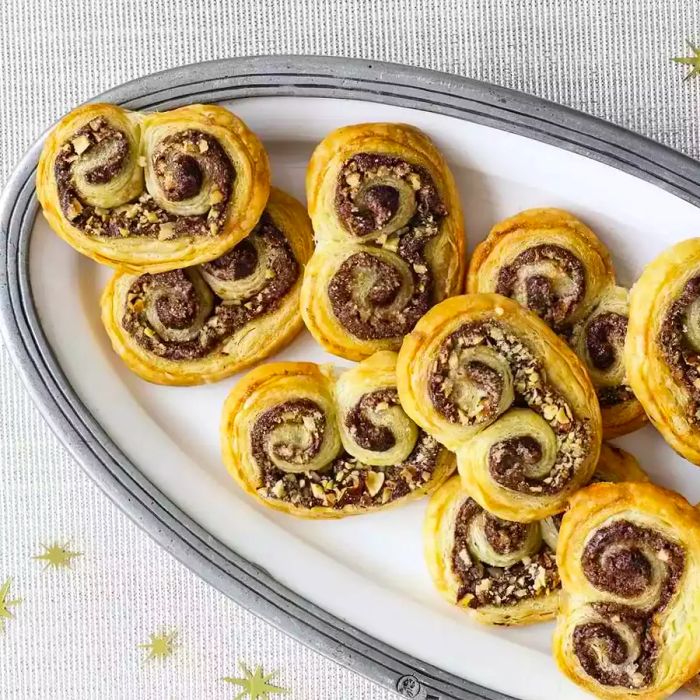 A plate of super simple Hazelnut Pastries made with puff pastry, Nutella, and chopped hazelnuts