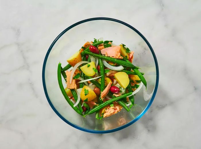 Untossed Salad Niçoise in a glass bowl.