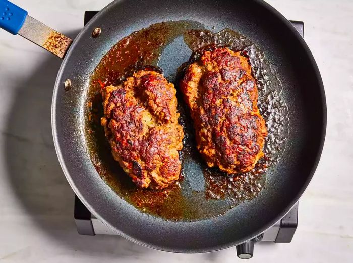 Brown the meat in a skillet, then simmer until fully cooked through.