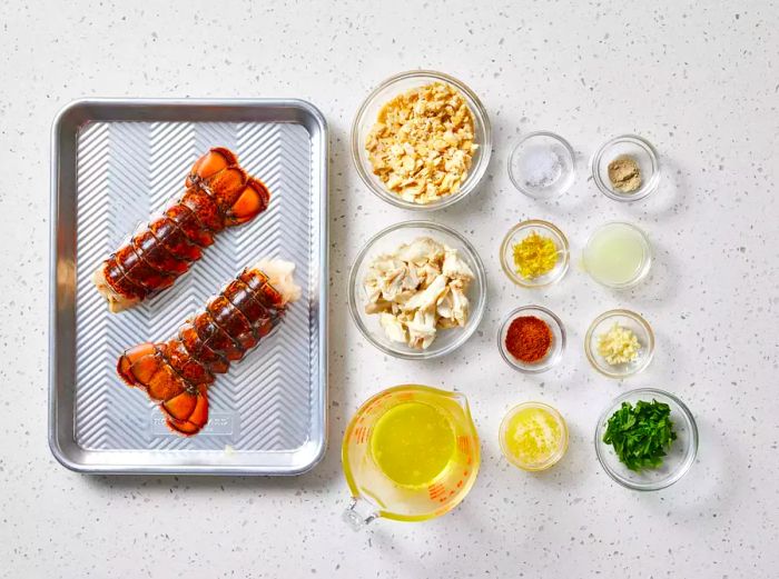 Ingredients for Crab-Stuffed Lobster Tails arranged on a tray with glass bowls