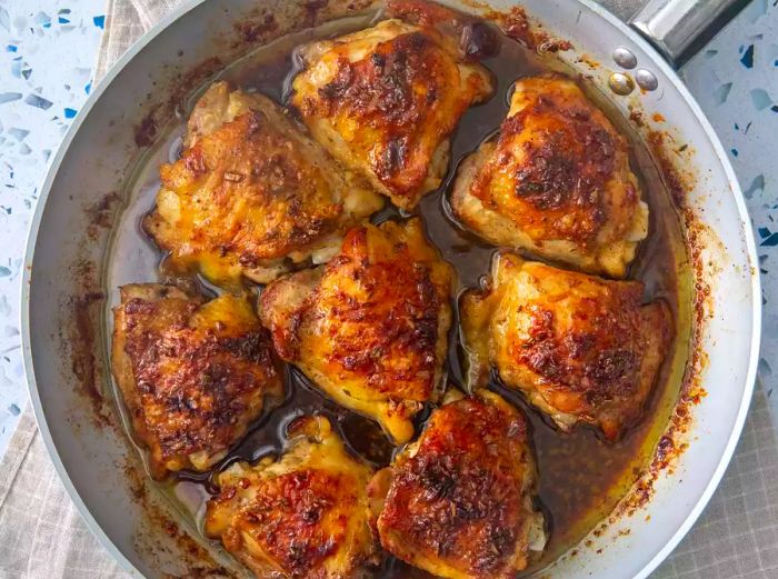 Aerial view of garlic brown sugar chicken thighs served in a skillet.