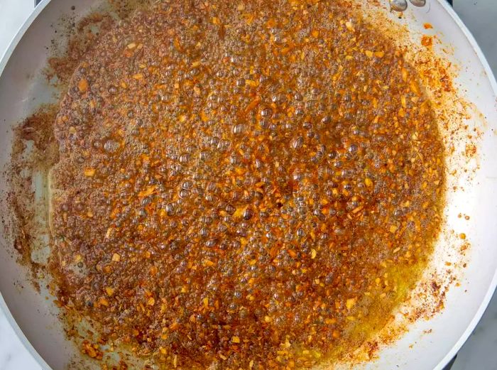 Stir in the brown sugar, honey, oregano, thyme, and basil until fully combined.