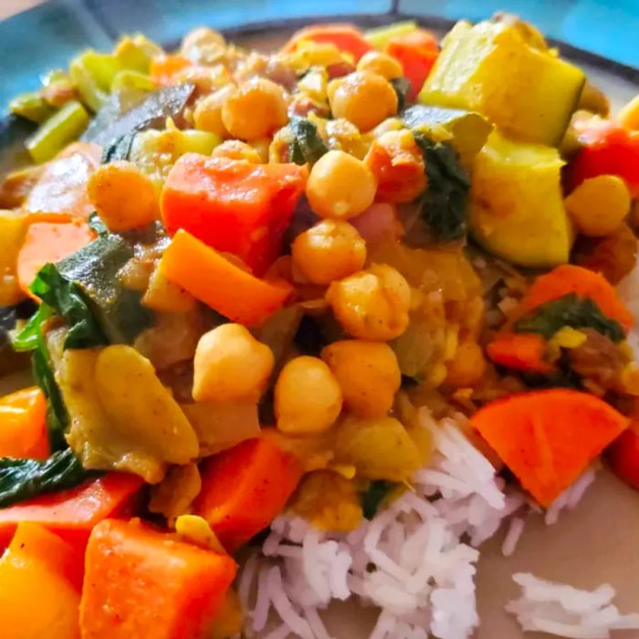 Close-up shot of Marrakesh Vegetable Curry served over white rice on a plate.