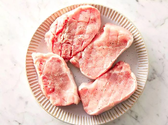 top view of raw pork chops on a plate