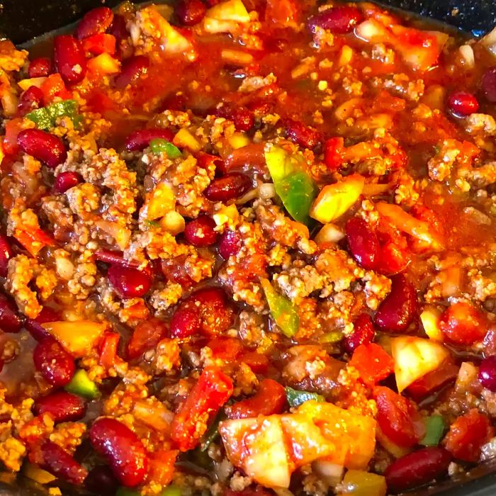 Close-up shot of spicy chili simmering in a slow cooker