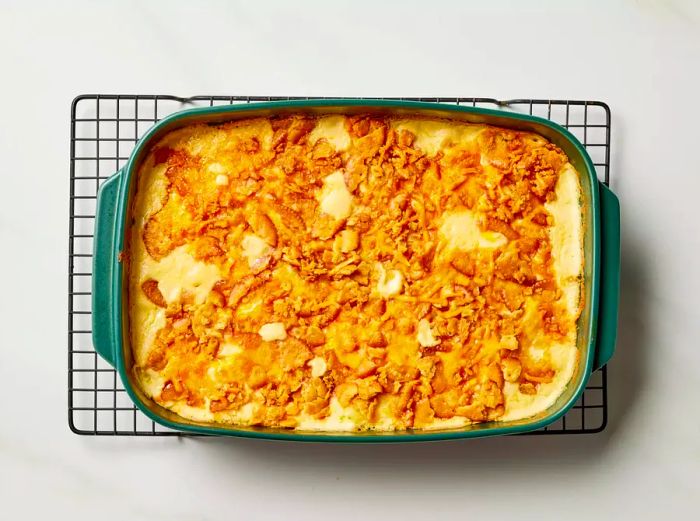 Million Dollar Potato Casserole resting on a cooling rack after baking.