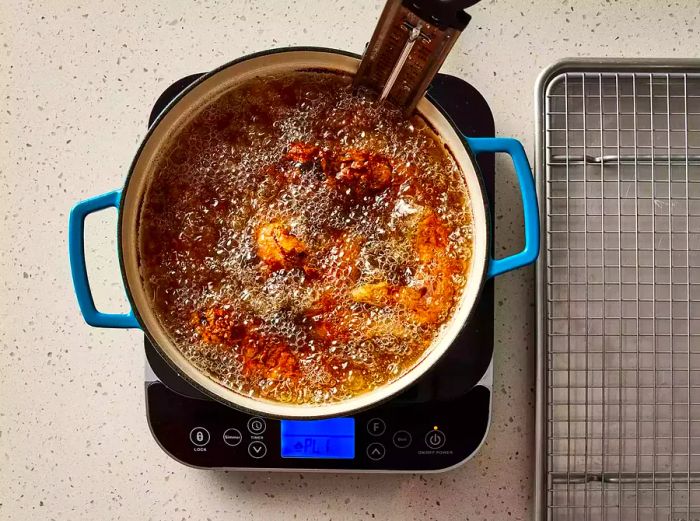 chicken frying in bubbling hot oil