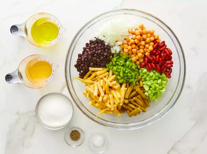 Sugar, oil, vinegar, salt, and pepper with the bean mixture.