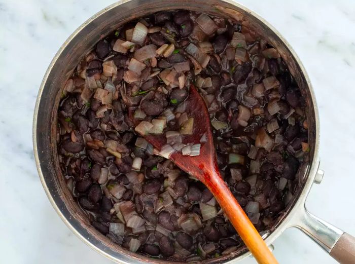 A saucepan simmering with the bean mixture.