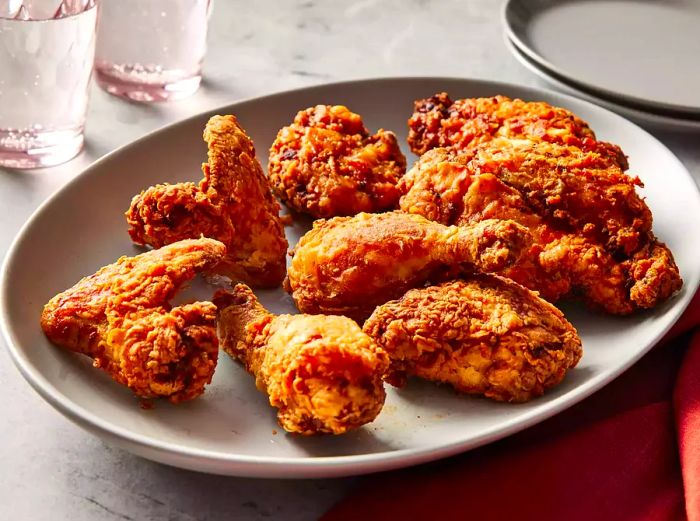 a plate of golden buttermilk fried chicken served on a white dish