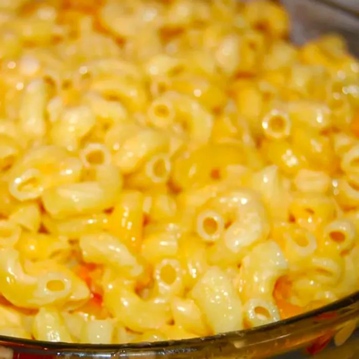 Close-up of a serving of Classic Macaroni and Cheese in a glass dish.