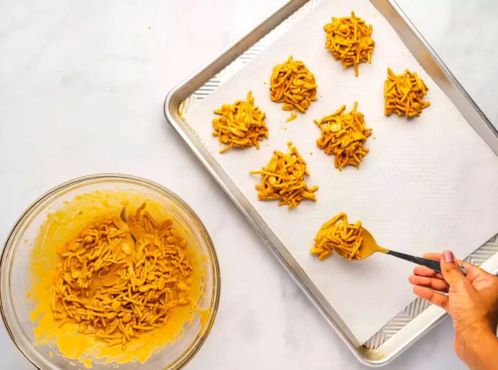 placing haystacks onto the tray with a fork