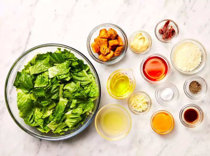 All the ingredients are now ready for preparing a classic Caesar salad like a restaurant.