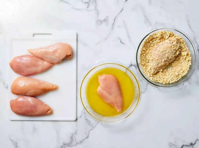 Chicken dipped in melted margarine, then coated with the cracker mixture.