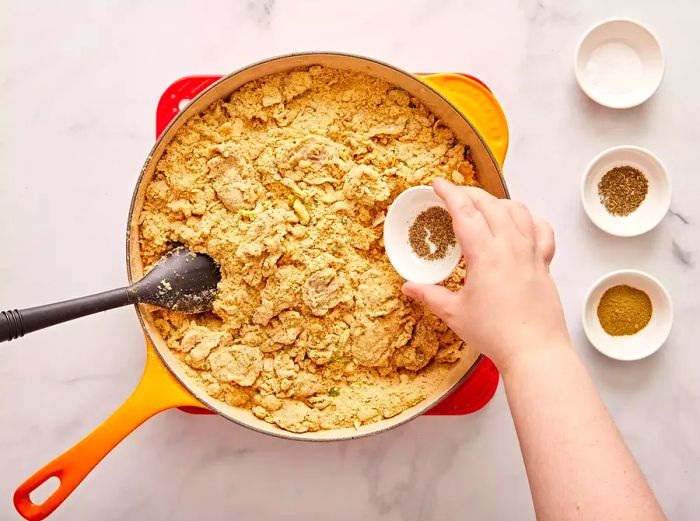 A bird’s-eye view of ingredients being stirred together in a pan for the oyster dressing.