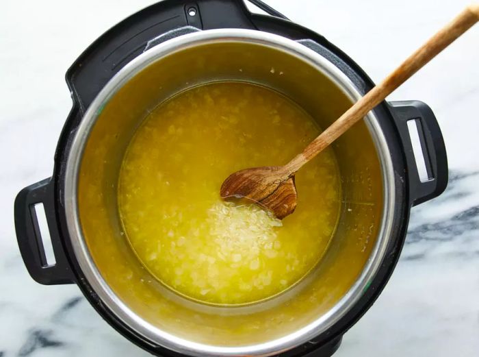 Chicken stock being added to an Instant Pot.