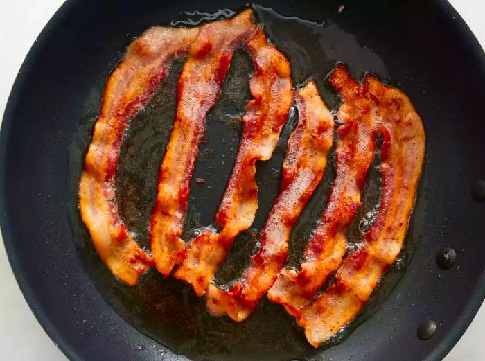 Bacon sizzling in a skillet