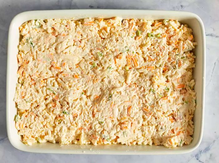 An overhead view of the unbaked potato casserole mixture