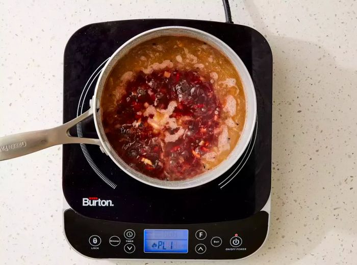 Black rice simmering in a pot on the stove