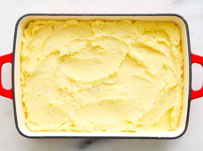 A dish filled with creamy mashed potatoes