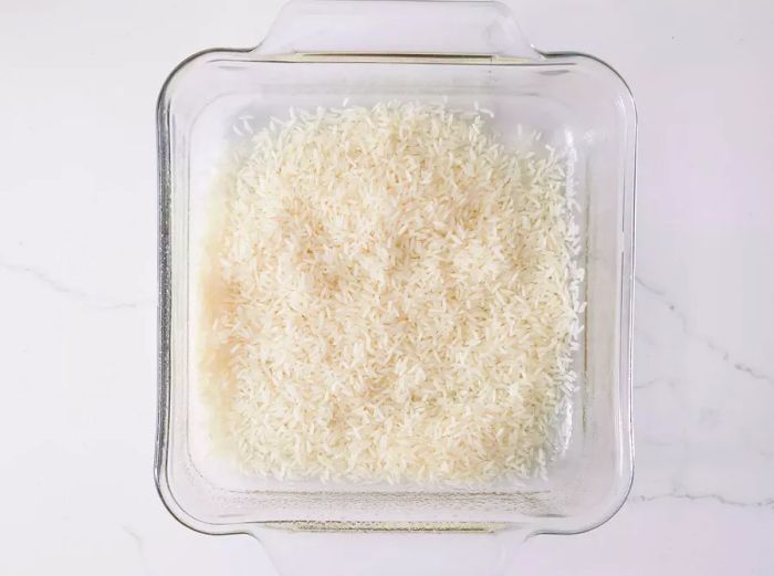A greased dish filled with rice